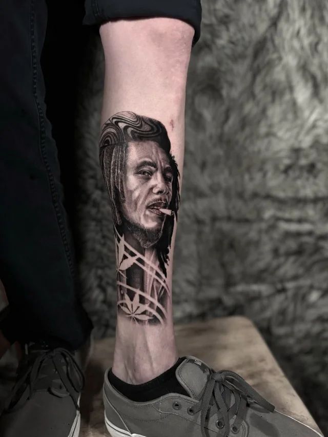 Male portrait over an outlined hourglass and geometric lines on a lower leg.
