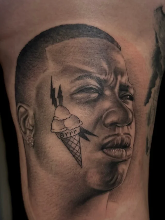 Male portrait with a cheek motif and bold surrounding graphic shapes on an upper arm.