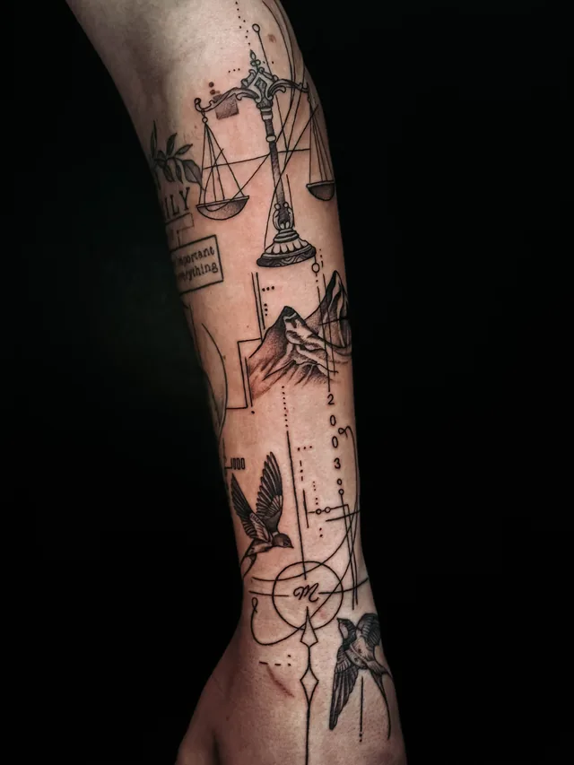 Forearm tattoo combining a balance scale, mountains and birds with thin geometric lines, circles and small numerals.