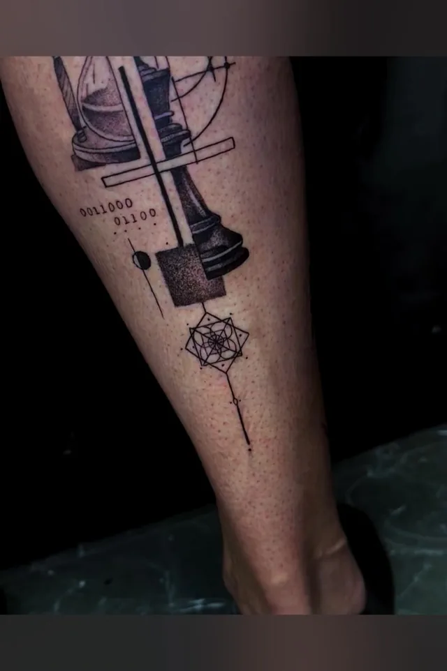 Detail of the chess piece and small lower rosette in the same lower-leg tattoo.