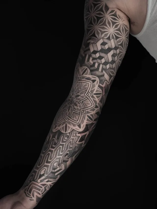 Geometric arm sleeve with overlapping petal circles, an interlocking cube pattern and a pointed mandala.