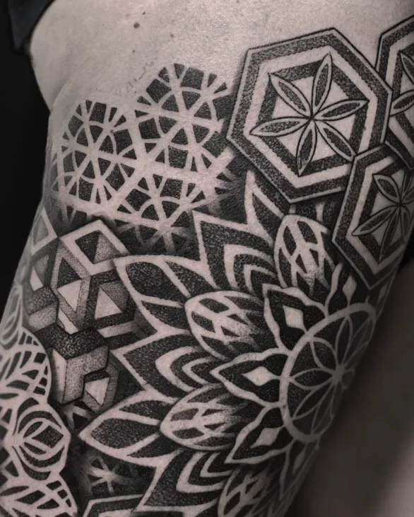 Close view of the hexagonal panels and layered rosette in the same upper-arm geometric tattoo.