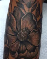 Close view of the flower petals in the floral forearm tattoo. Artwork by William Martz.