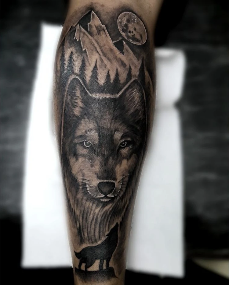 A black-and-gray wolf portrait combined with mountain peaks and forest shapes.