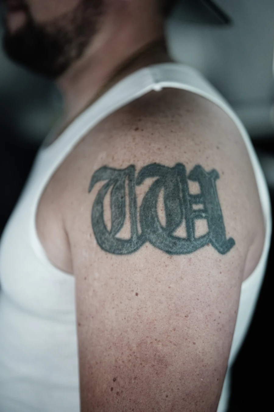 Before the cover-up: large dark lettering on the upper arm.