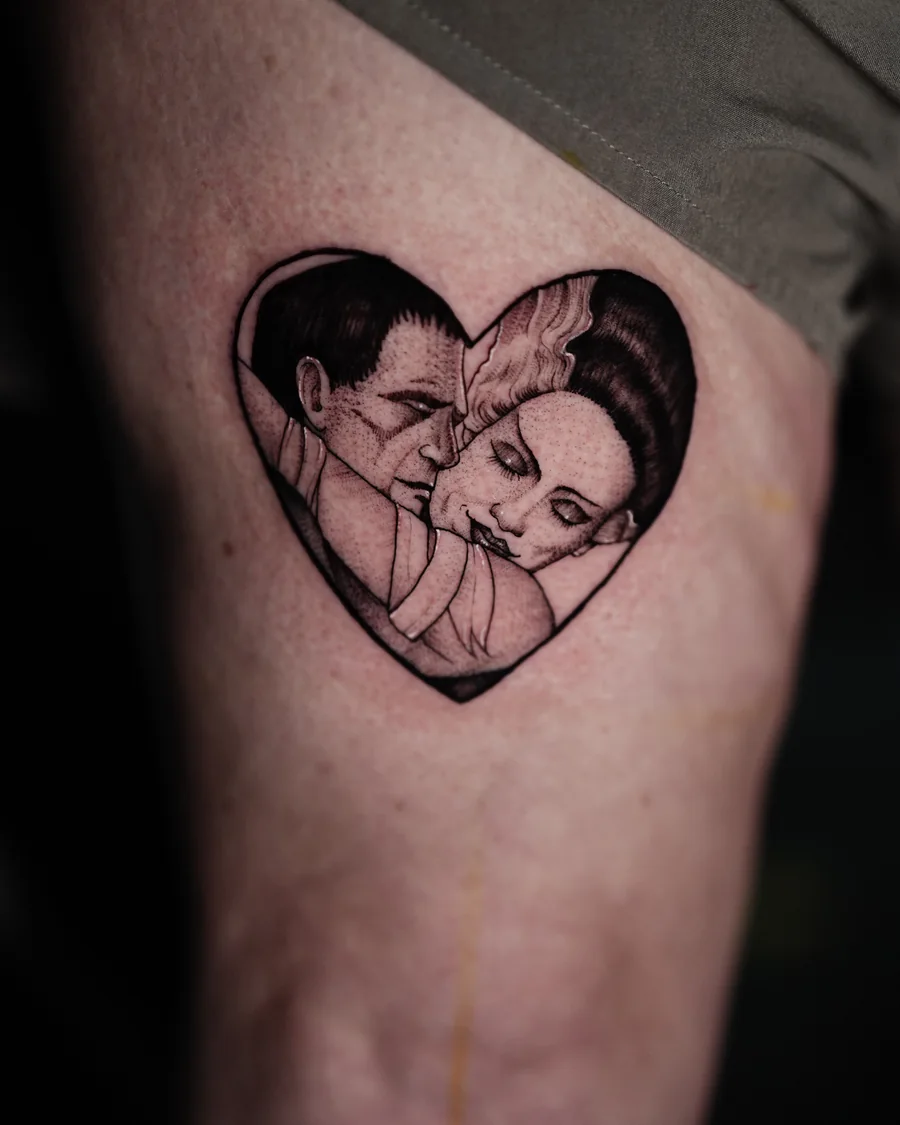 Alternate view. Gomez and Morticia Addams appear together inside a heart-shaped black-and-gray tattoo.
