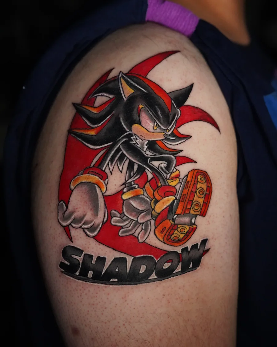 A red, black and yellow Shadow the Hedgehog tattoo with the character's name beneath the figure.