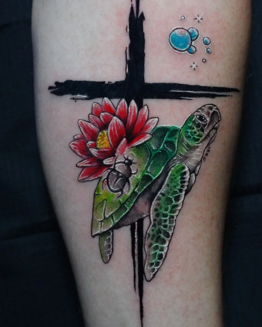 A green sea turtle and red flower beside a dark brushstroke cross, with small blue bubbles above.