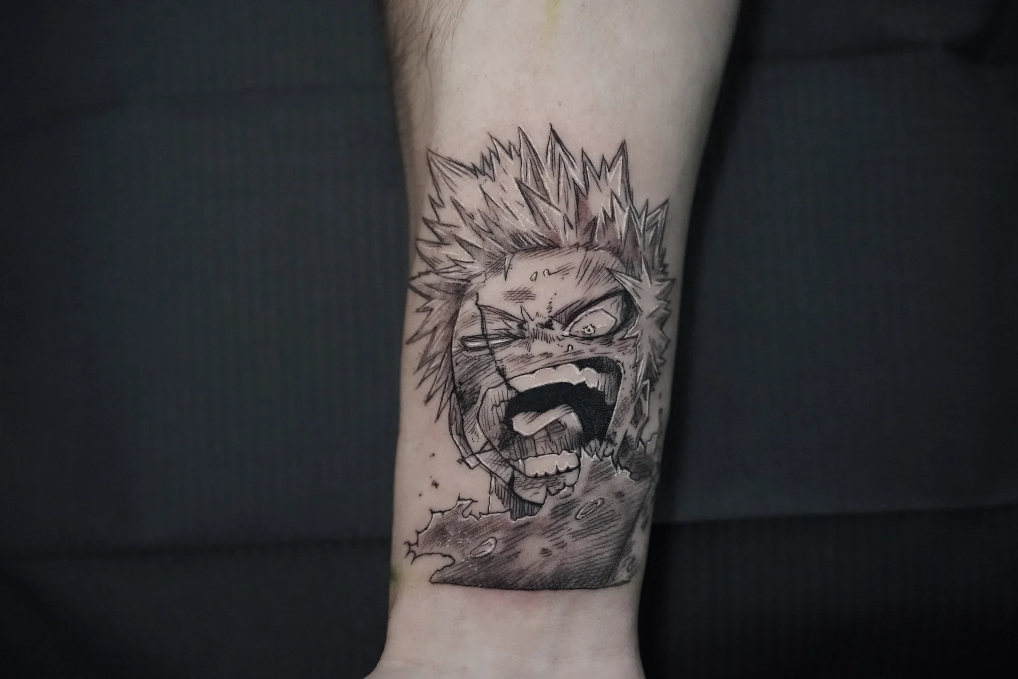 A black-and-gray anime portrait with spiked hair, a dark eye mask and an open mouth.