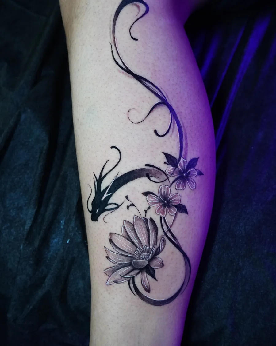 A slender floral vine with shaded blossoms and sweeping curved stems along the arm.