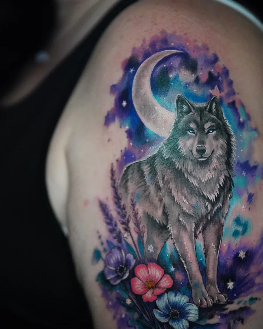 Alternate view. A wolf standing below a crescent moon, surrounded by purple and blue watercolor-like color and small flowers.