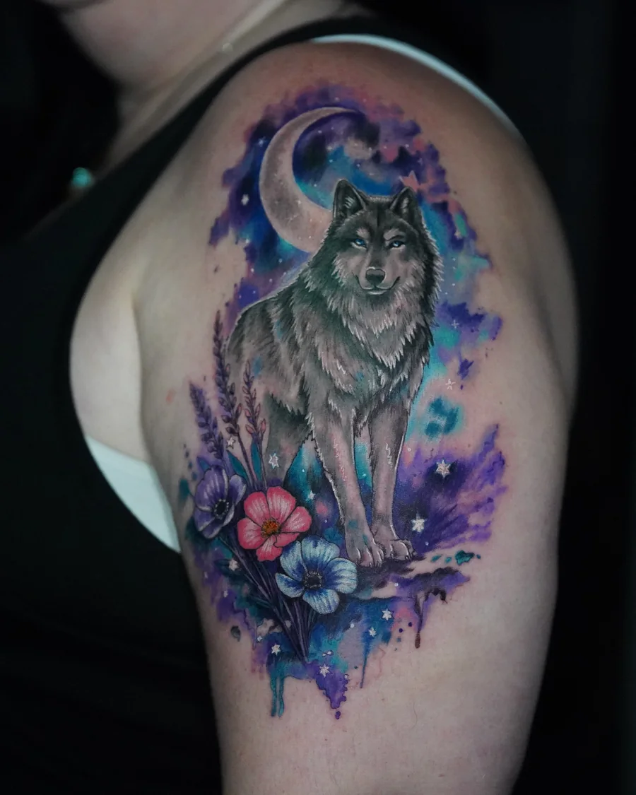 Alternate view. A wolf standing below a crescent moon, surrounded by purple and blue watercolor-like color and small flowers.