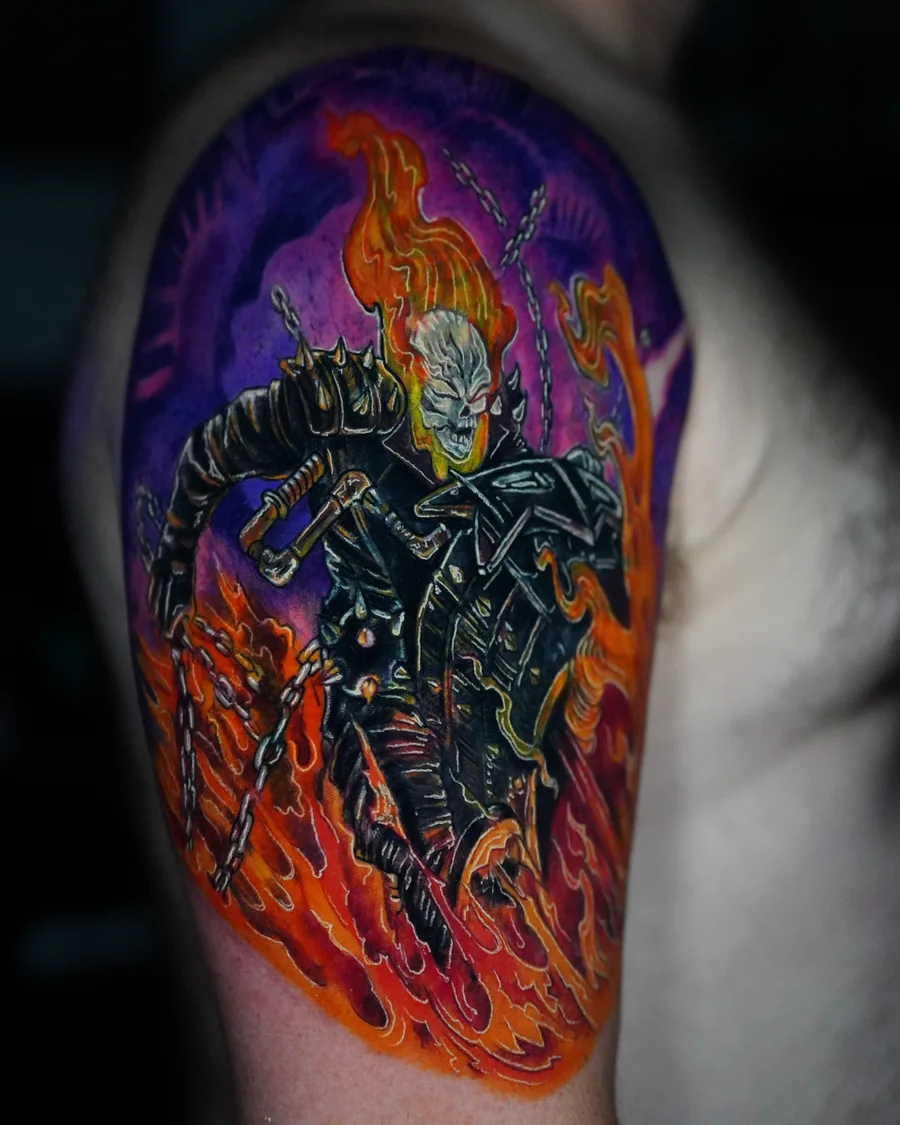 Alternate view. A flaming skull rider in a dark jacket with a chain, surrounded by vivid orange fire and a purple background.