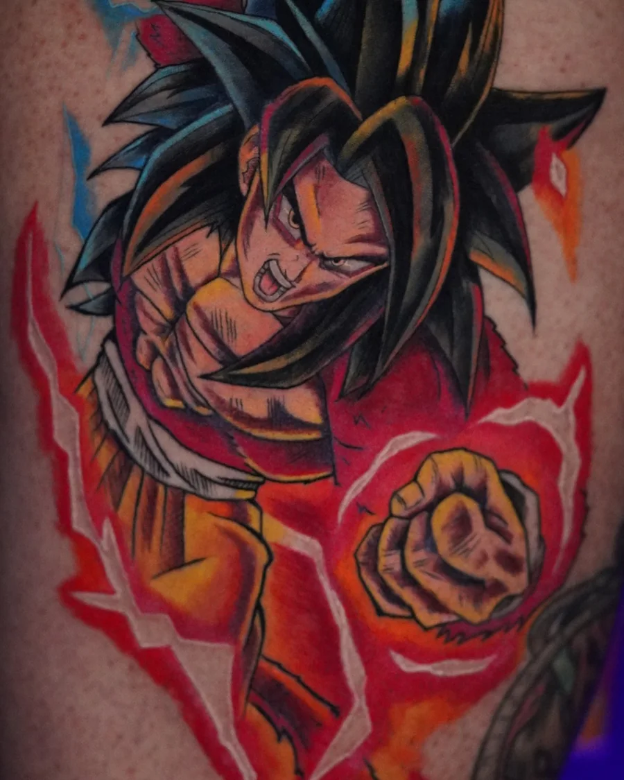 A brightly colored anime fighter with long spiked black hair, a red upper body and a yellow and red aura.