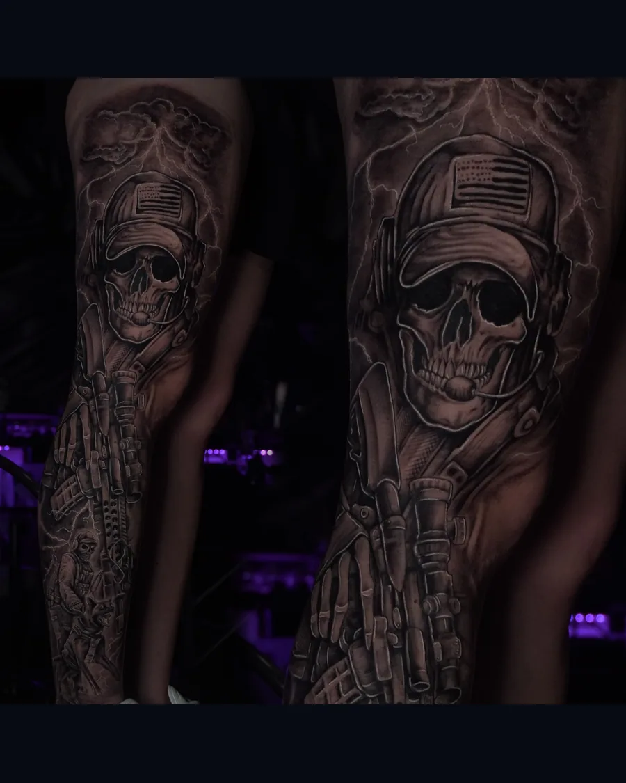 A black-and-gray leg tattoo featuring a skull in a cap and headset, military equipment, and lightning, shown in a full view and a close-up.