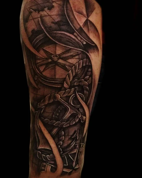 A black-and-gray nautical composition combining a compass, rope, and an anchor.