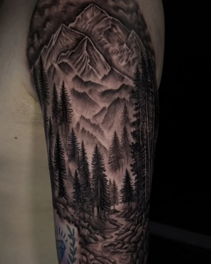 A black-and-gray mountain landscape framed by dense pine trees and curved decorative details on the arm.